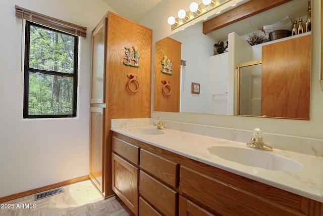 9434 W Obier Dr, Pine, AZ 85544 - bathroom featuring double vanity, a shower with shower door, and baseboards