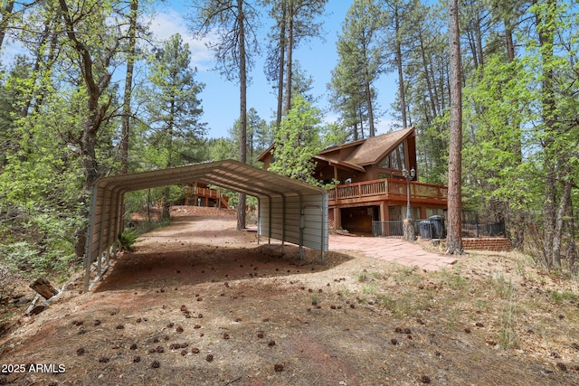9434 W Obier Dr, Pine, AZ 85544 - view of side of home with a detached carport, dirt driveway, and a wooden deck