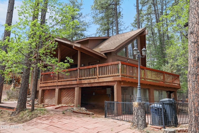9434 W Obier Dr, Pine, AZ 85544 - view of front facade featuring a patio, a wooden deck, and roof with shingles