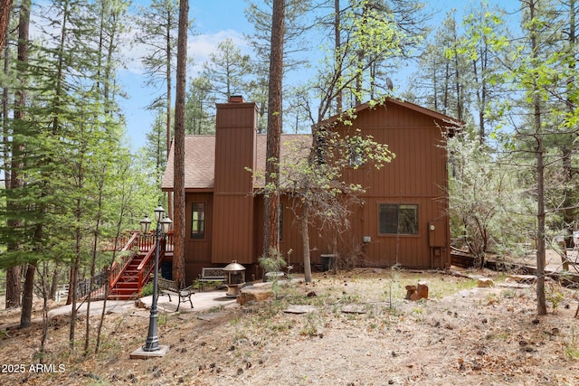 9434 W Obier Dr, Pine, AZ 85544 - view of home's exterior with a chimney, roof with shingles, and stairs