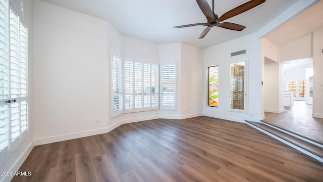 unfurnished room featuring ceiling fan and dark hardwood / wood-style flooring