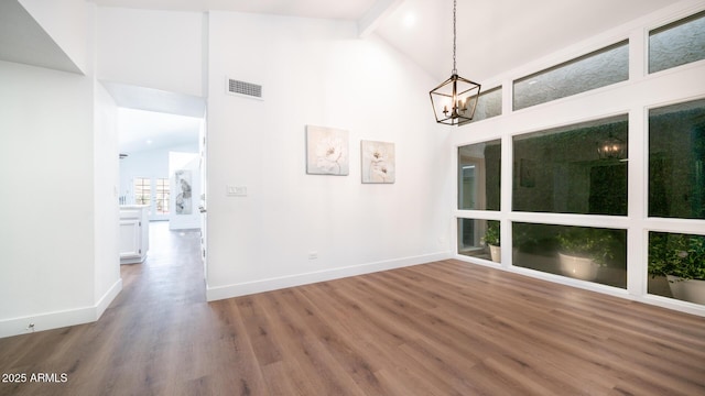 interior space featuring a chandelier, hardwood / wood-style flooring, beamed ceiling, and high vaulted ceiling