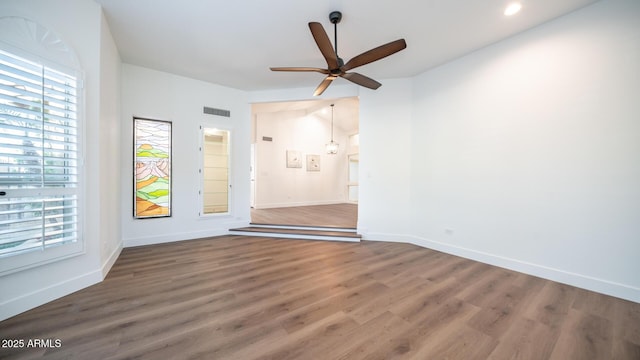 spare room featuring ceiling fan and dark hardwood / wood-style floors