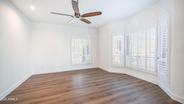 empty room featuring ceiling fan and dark hardwood / wood-style floors