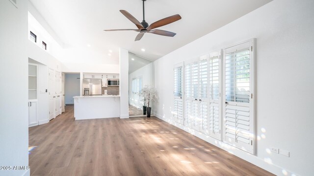 unfurnished living room featuring light hardwood / wood-style floors and ceiling fan