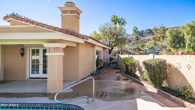 view of patio / terrace featuring a mountain view and french doors