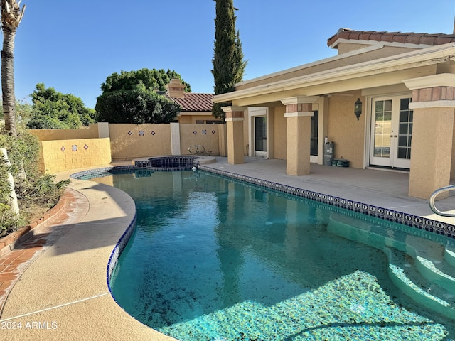 view of swimming pool featuring french doors and a patio area