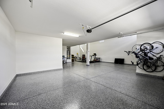 garage with baseboards and a garage door opener