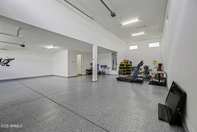 garage featuring baseboards and gas water heater