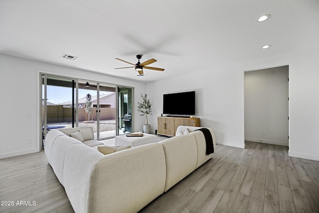 living area featuring recessed lighting, baseboards, visible vents, and light wood finished floors