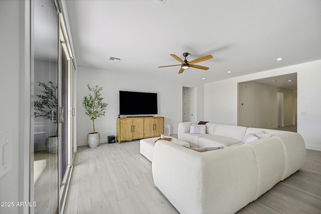 living room with recessed lighting, visible vents, a ceiling fan, light wood-type flooring, and baseboards