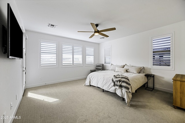 carpeted bedroom featuring baseboards, visible vents, and a ceiling fan