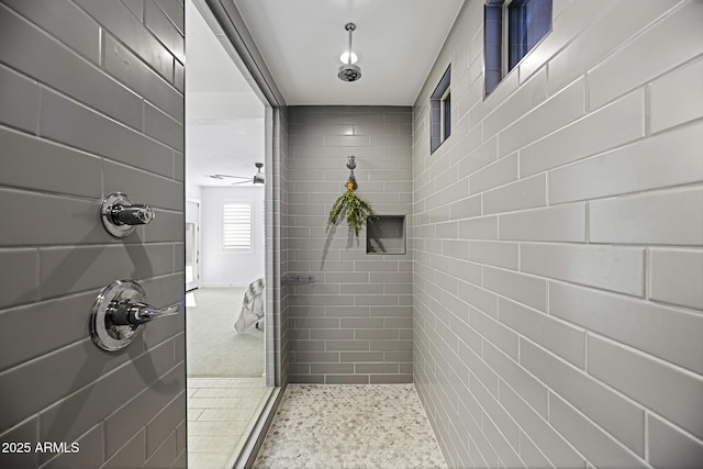 full bath featuring tile patterned flooring and a tile shower