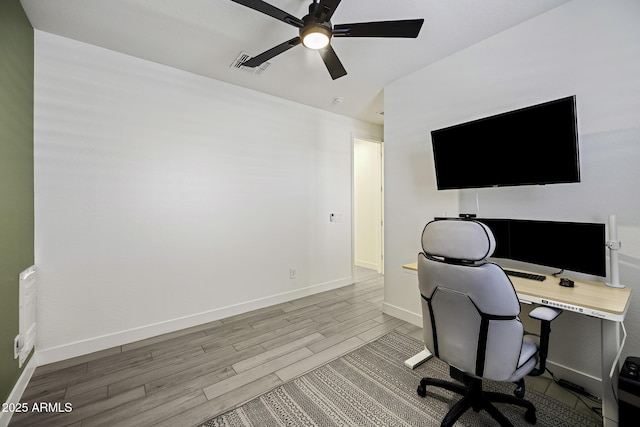 office space with baseboards, visible vents, ceiling fan, and wood finish floors