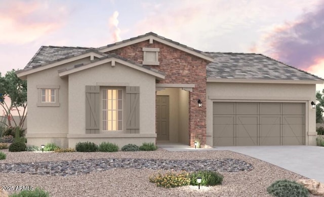 traditional-style home featuring an attached garage, stucco siding, driveway, and stone siding