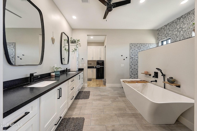 26112 N 7th Ave, Phoenix, AZ 85085 - bathroom featuring a ceiling fan, double vanity, a freestanding bath, baseboards, and recessed lighting
