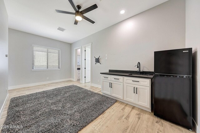 26112 N 7th Ave, Phoenix, AZ 85085 - kitchen featuring freestanding refrigerator, a sink, light wood-style flooring, ceiling fan, and white cabinets