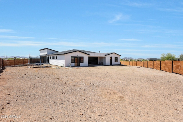 26112 N 7th Ave, Phoenix, AZ 85085 - view of front of home with a trampoline, a fenced backyard, and board and batten siding