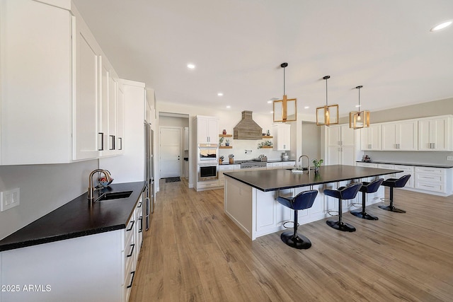 26112 N 7th Ave, Phoenix, AZ 85085 - kitchen featuring a sink, dark countertops, a breakfast bar area, an island with sink, and recessed lighting