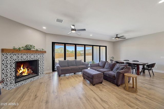26112 N 7th Ave, Phoenix, AZ 85085 - living room featuring ceiling fan, light wood finished floors, recessed lighting, a fireplace, and baseboards