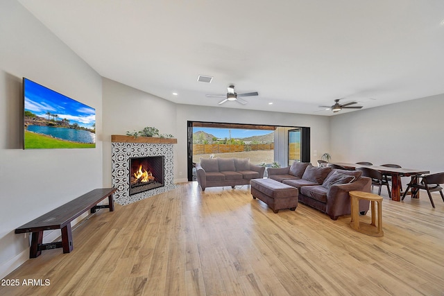 26112 N 7th Ave, Phoenix, AZ 85085 - living area featuring light wood finished floors, a ceiling fan, a fireplace, recessed lighting, and baseboards