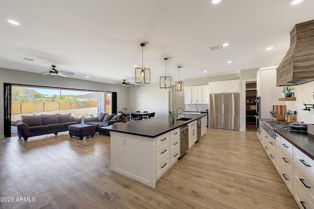 26112 N 7th Ave, Phoenix, AZ 85085 - kitchen with appliances with stainless steel finishes, dark countertops, ceiling fan, a sink, and light wood-style flooring