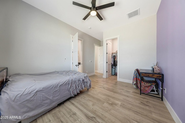 26112 N 7th Ave, Phoenix, AZ 85085 - bedroom featuring light wood-style floors, a spacious closet, baseboards, and a ceiling fan