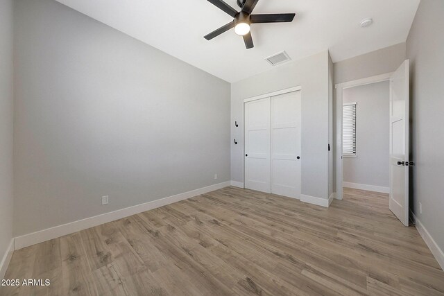 26112 N 7th Ave, Phoenix, AZ 85085 - unfurnished bedroom with light wood-style flooring, a closet, baseboards, and a ceiling fan