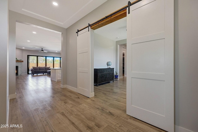 26112 N 7th Ave, Phoenix, AZ 85085 - corridor featuring a barn door, light wood-style floors, baseboards, and recessed lighting