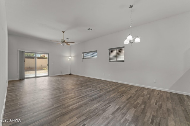 unfurnished room featuring baseboards and dark wood-style floors