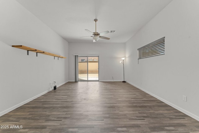 spare room featuring ceiling fan, visible vents, baseboards, and wood finished floors