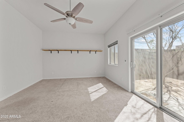 empty room with light carpet, a ceiling fan, and baseboards