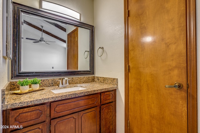 bathroom with vaulted ceiling with beams, ceiling fan, and vanity