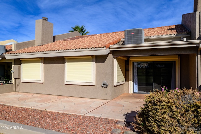 rear view of property featuring central AC and a patio area