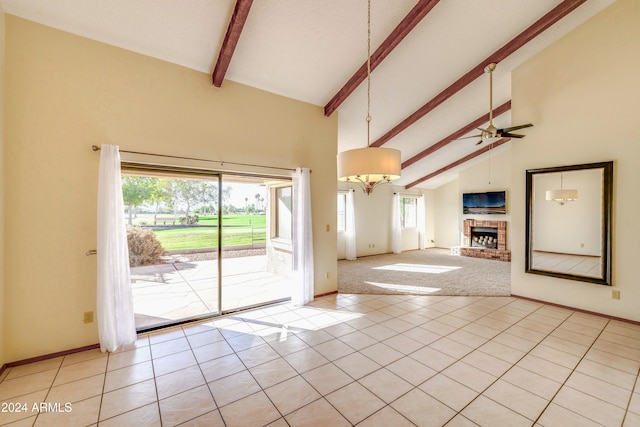 unfurnished living room with beam ceiling, high vaulted ceiling, a wealth of natural light, and ceiling fan