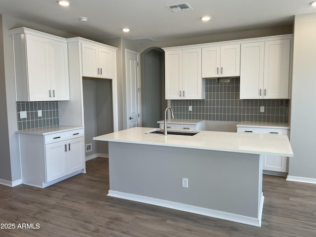 24146 N 162nd Ln, Surprise, AZ 85387 - kitchen with a sink, backsplash, white cabinets, a center island with sink, and baseboards