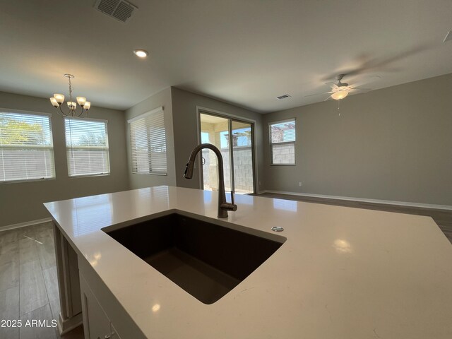 24146 N 162nd Ln, Surprise, AZ 85387 - kitchen featuring a sink, wood finished floors, a ceiling fan, a chandelier, and recessed lighting