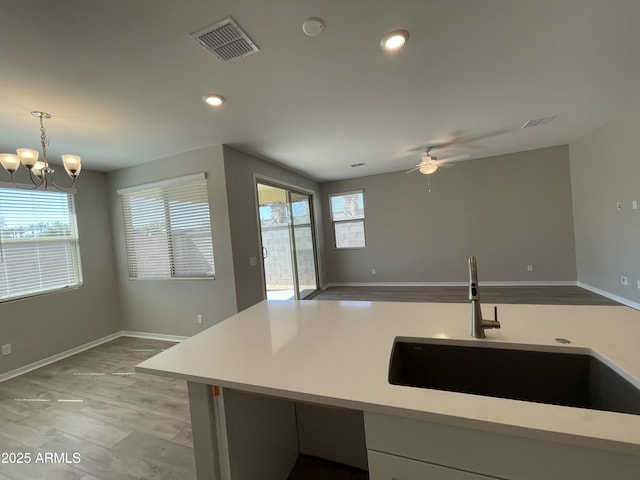 24146 N 162nd Ln, Surprise, AZ 85387 - kitchen with a sink, light countertops, a ceiling fan, open floor plan, and baseboards