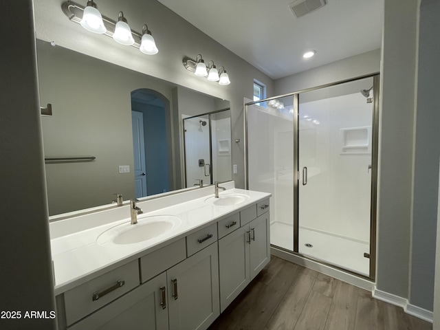 24146 N 162nd Ln, Surprise, AZ 85387 - bathroom featuring wood finished floors, a shower stall, and double vanity