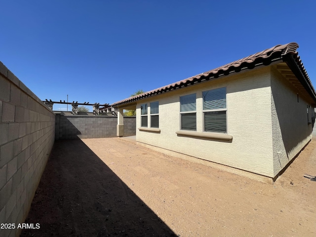 24146 N 162nd Ln, Surprise, AZ 85387 - view of property exterior with a fenced backyard, stucco siding, and a tiled roof