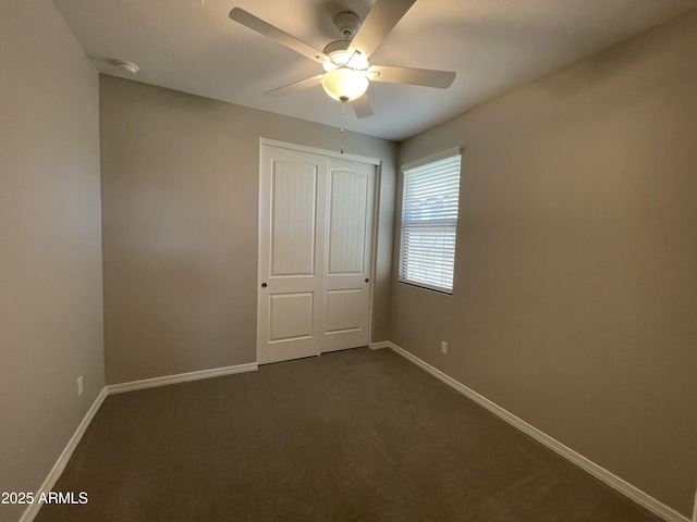 24146 N 162nd Ln, Surprise, AZ 85387 - unfurnished bedroom with baseboards, a closet, dark carpet, and ceiling fan