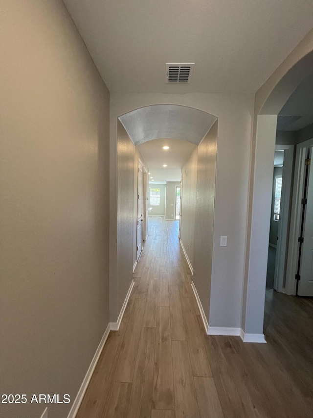 24146 N 162nd Ln, Surprise, AZ 85387 - corridor featuring arched walkways, wood finished floors, and baseboards
