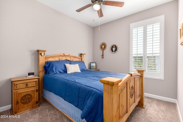 bedroom featuring multiple windows, ceiling fan, and light carpet