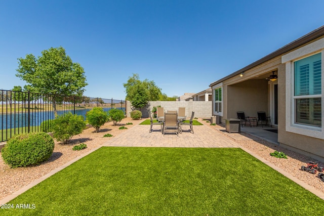 view of yard with a patio area and a water view