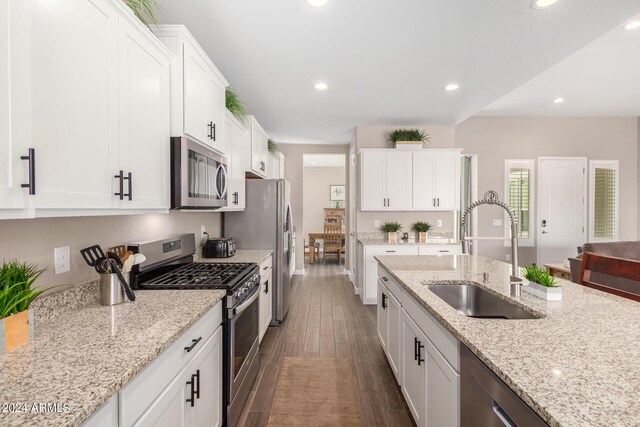 kitchen with white cabinetry, light stone countertops, sink, and stainless steel appliances