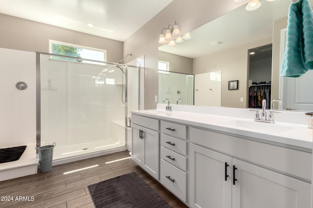 bathroom with vanity and a shower with door