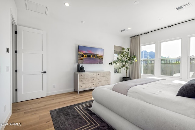 bedroom with hardwood / wood-style floors