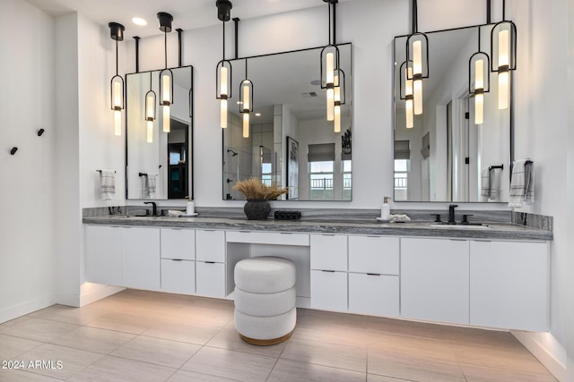 bathroom with vanity and a shower with shower door