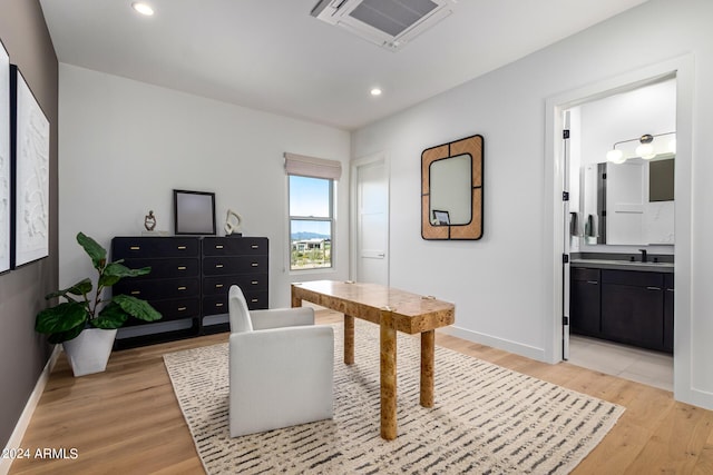 office space featuring sink and light hardwood / wood-style floors