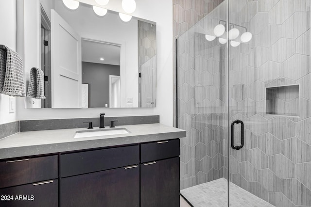 bathroom with vanity and a shower with door